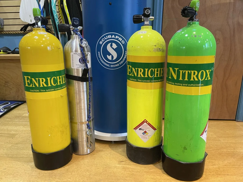 Enriched air nitrox scuba cylinders with distinctive green and yellow markings